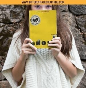 Girl holding Ghost by Jason Reynolds