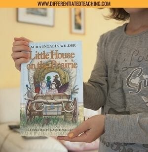 Child holding Little House on the Prairie 