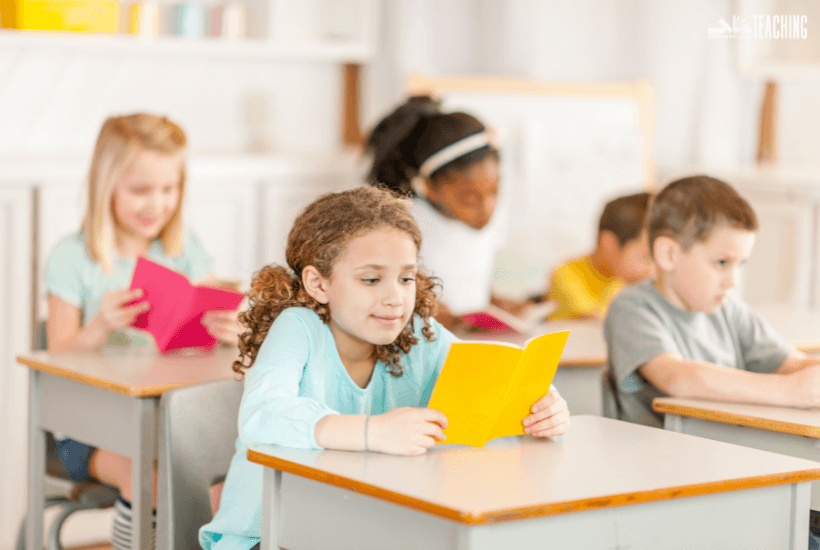 elementary students sitting at desks choral reading in class