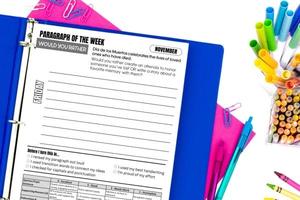 A binder with a worksheet titled “Paragraph of the Week” is open on a desk. Surrounding the binder are colorful pens, pencils, paper clips, and a notepad—perfect for kids to explore creative writing prompts and would you rather questions.