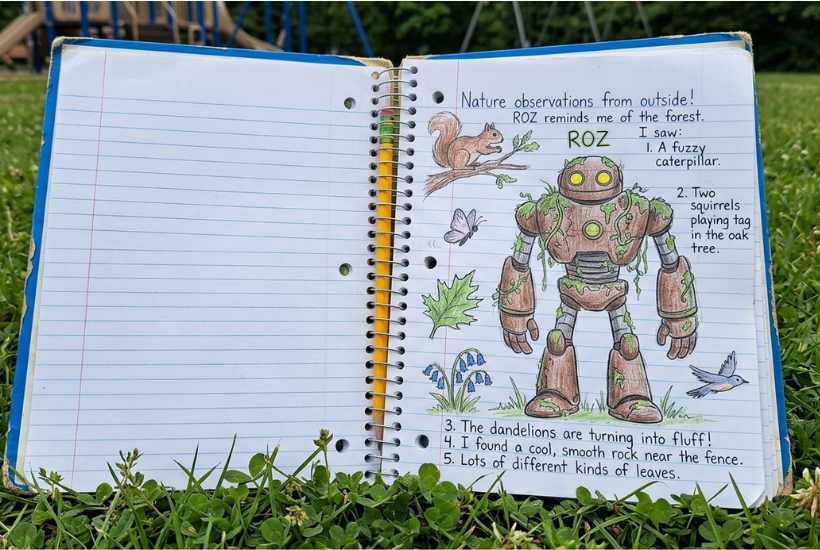 An open notebook lies on grass. The right page features a drawing of a robot, squirrel, leaves, and bird, with handwritten nature notes—perfect for a Wild Robot novel study or as a classroom guide for outdoor observation activities.