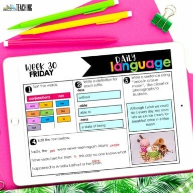 An iPad on a white desk displays a colorful “4th Grade Daily Language Review” worksheet with vocabulary sorting, suffix definitions, sentence writing, and grammar activities. Nearby are pink, yellow, and green pens and tropical leaves.